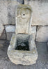 Fuente de piedra de pared.
