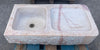 Antiguo fregadero de marmol rosa.