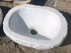 Lavabo ovalado de mármol.