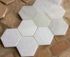 Losa de mármol hexagonal abujardada.