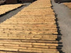 Vigas de madera redondas muy finas de 2,5 metros.
