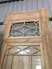 Puerta de madera restaurada cristalera con tragaluz.