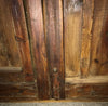 Portón de clavos restaurado con puerta de paso.